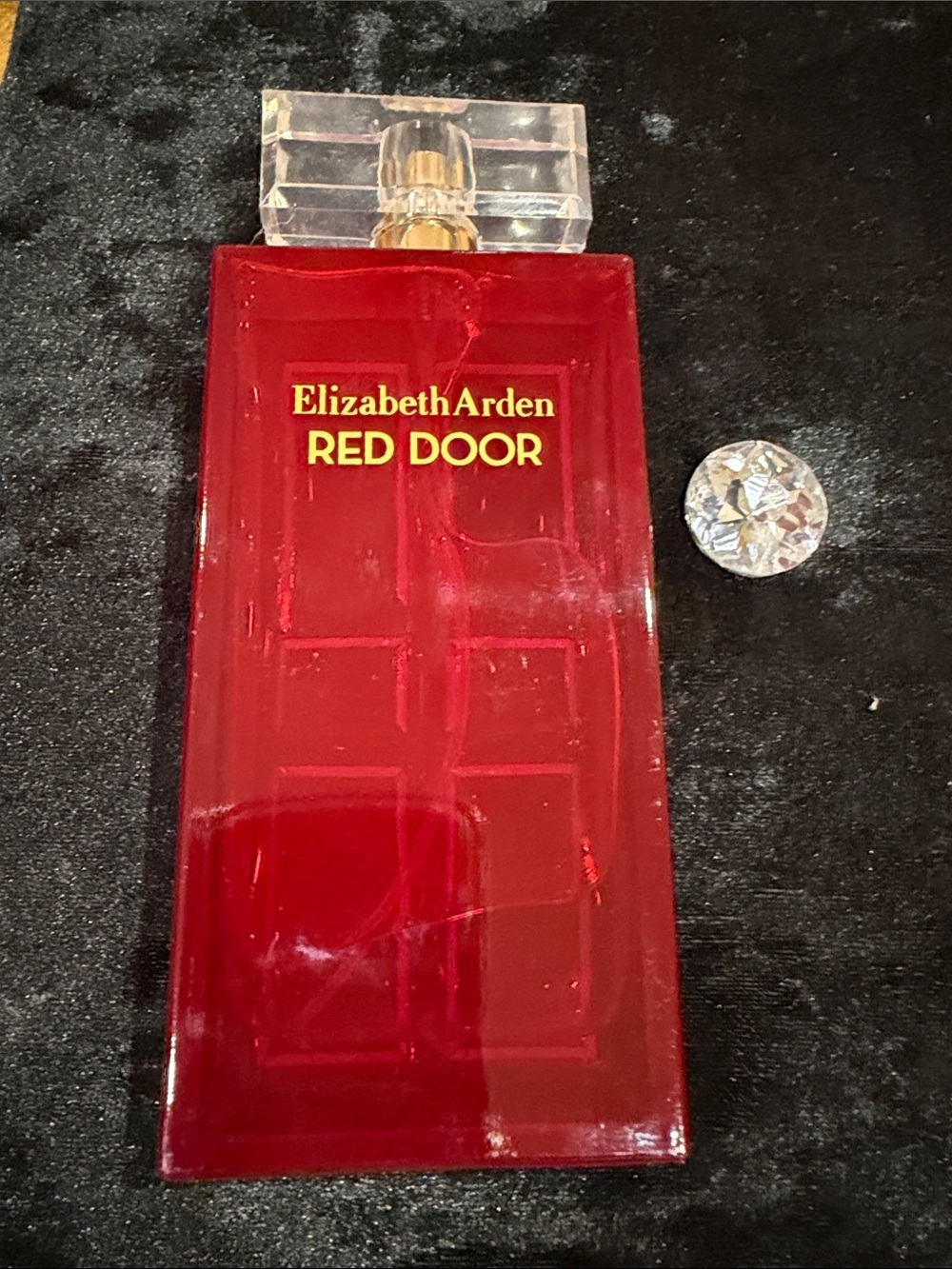 Elizabeth Arden Red Door Perfume Bottle in Clear-Capped Red and Gold Accents
